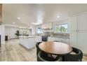 This bright kitchen features a center island, modern appliances, and a cozy dining area at 8463 W Arizona Dr, Lakewood, CO 80232