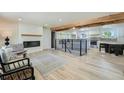 Bright living room showcases hardwood floors, wooden beams, a fireplace, and an open floor plan at 8463 W Arizona Dr, Lakewood, CO 80232
