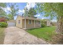 Side view of a home with a detached garage and a driveway at 2921 S Holly Pl, Denver, CO 80222