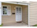 A close-up of the front door featuring a screen door and decorative details at 2921 S Holly Pl, Denver, CO 80222