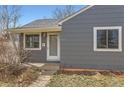 Front entry view of single story home showcasing the front door and updated facade at 755 Newark St, Aurora, CO 80010
