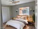 Bright bedroom with a queen bed, soft lighting, and views of outdoor scenery at 1415 Bacchus Dr # D9, Lafayette, CO 80026