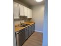 Compact kitchen featuring white cabinets, stainless steel appliances, and modern fixtures at 1415 Bacchus Dr # D9, Lafayette, CO 80026