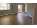 Spacious living room featuring new floors, large windows and access to the outdoors at 1415 Bacchus Dr # D9, Lafayette, CO 80026