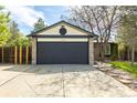 Two-car garage with stone accents and detailed trim work, featuring a well-maintained driveway and landscaping at 11524 Marshall Ct, Broomfield, CO 80020