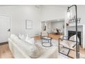 Spacious living room with high ceilings, fireplace, modern furniture, and an open concept design at 2275 S Yosemite Cir, Denver, CO 80231