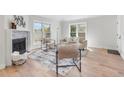 Bright living room with a fireplace, modern furniture, and ample natural light for a cozy atmosphere at 2275 S Yosemite Cir, Denver, CO 80231