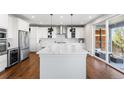 Bright kitchen with quartz countertops, stainless steel appliances, and white cabinets at 11023 Pastel Pt, Parker, CO 80134