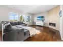 Inviting living room featuring a sleek fireplace, large windows and a comfortable seating arrangement at 11023 Pastel Pt, Parker, CO 80134