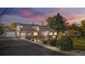 Beautiful home exterior with custom stone accents, a new roof, tasteful landscaping, and an attached garage at 1945 Yarrow St, Lakewood, CO 80214