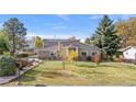 Charming home with a well-maintained lawn and mature trees at 1945 Yarrow St, Lakewood, CO 80214