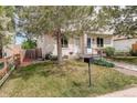 Charming exterior view of a home with green lawn, complemented by mature trees at 4720 S Bannock St, Englewood, CO 80110