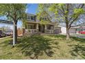 A well-maintained home with a front porch, green lawn and a 'Coming Soon' sign at 591 Rio Rancho Way, Brighton, CO 80601