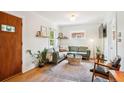 Bright living room featuring a comfortable green sofa, hardwood floors, and ample natural light at 3622 Lowell Blvd, Denver, CO 80211