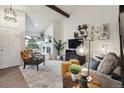 Cozy living room with a fireplace, stylish decor, and plenty of natural light at 6948 Buckskin Dr, Littleton, CO 80125