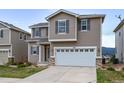 Two-story home with taupe siding, gray shutters, and a two-car garage in a well-maintained neighborhood at 1416 Red Mica Way, Monument, CO 80132