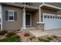 View of the front door and well manicured landscaping and rock ground cover surrounding the area at 1416 Red Mica Way, Monument, CO 80132