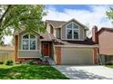 Lovely two-story home with a perfectly manicured front lawn and an attached two-car garage at 8555 Angela Ln, Parker, CO 80134