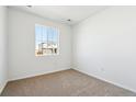 Bright bedroom featuring a large window and neutral carpeting at 4590 Boone Cir, Brighton, CO 80601
