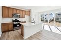 Modern kitchen featuring an island with white countertops and stainless steel appliances at 4590 Boone Cir, Brighton, CO 80601