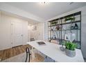 Stylish home office featuring modern shelving, sleek white desk, and contemporary decor at 13586 E 103Rd Pl, Commerce City, CO 80022