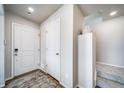 Bright entryway featuring a wood floor, gray rug, closet, and stairs leading to the upper level at 13586 E 103Rd Pl, Commerce City, CO 80022