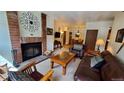 Living room with fireplace, leather furniture, and access to dining area at 555 S Park Ave # 202, Breckenridge, CO 80424