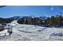 Sunny ski slope view with snow-covered ground and mountain background at 555 S Park Ave # 202, Breckenridge, CO 80424