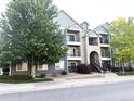 Apartment building with a blue exterior, multiple balconies, and well-maintained landscaping at 4451 S Ammons St # 108, Littleton, CO 80123
