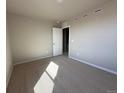 Comfortable bedroom with large windows and neutral-toned walls and carpet at 48299 Shetland Dr, Bennett, CO 80102