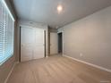Bright bedroom featuring a closet with sliding doors and neutral color palette at 48299 Shetland Dr, Bennett, CO 80102