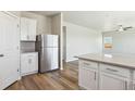 Kitchen view highlighting stainless steel refrigerator and spacious countertops at 48299 Shetland Dr, Bennett, CO 80102