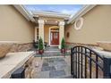 Charming front entrance with stone pathway, complemented by manicured plants and decorative ironwork at 5118 Bottlebrush Run, Broomfield, CO 80023