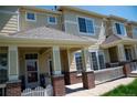 Inviting townhome showcasing a covered entrance with classic architectural details and well-maintained surroundings at 16180 E Geddes Ln # 14, Aurora, CO 80016