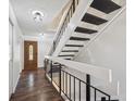 Bright entryway features stylish wood-look flooring, a wooden door, and a staircase at 7755 E Quincy Ave # T2, Denver, CO 80237