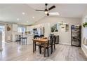 Light and airy dining area with a wooden table and a view into the modern kitchen at 690 Howe Ct, Castle Rock, CO 80104