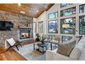 Bright living room with stone fireplace and mountain views at 699 Highlands Dr, Breckenridge, CO 80424