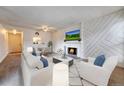 Inviting living room with a decorative fireplace, modern furniture, and a mounted TV at 6420 S Dayton St # J07, Englewood, CO 80111