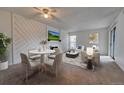 Open-concept living space featuring a dining area, stylish decor, and ample natural light at 6420 S Dayton St # J07, Englewood, CO 80111