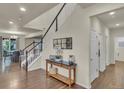 Elegant foyer with hardwood floors, a staircase, and stylish decor leading into the dining room at 3762 White Rose Loop, Castle Rock, CO 80108