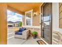 Cozy front porch featuring a comfortable chair, stone accents, and a welcoming entrance at 3762 White Rose Loop, Castle Rock, CO 80108
