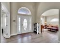 Inviting foyer showcasing a decorative glass front door, high ceilings, and seamless flow into the living area at 6943 Saddleback Ave, Firestone, CO 80504