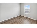 Neutral colored bedroom with wood flooring and natural light coming through the window at 2214 Alyssa St, Fort Lupton, CO 80621
