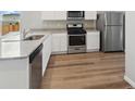 Modern kitchen features stainless steel appliances, granite countertops and hard wood flooring at 2214 Alyssa St, Fort Lupton, CO 80621