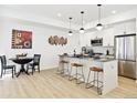 Open concept kitchen boasts modern island with seating and stainless steel appliances at 3101 W 47Th Ave # 17, Denver, CO 80211