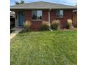 Ranch style brick home with a well-maintained lawn at 3608 N Grape St, Denver, CO 80207