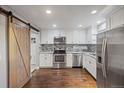 Modern kitchen with stainless steel appliances and granite countertops at 3608 N Grape St, Denver, CO 80207