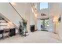 Bright living room boasts high ceilings, a cozy fireplace, and sliding glass doors to a balcony at 3260 47Th St # 201A, Boulder, CO 80301