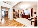 Bright living room with hardwood floors, a wood burning fireplace and plenty of natural light at 5808 S Duquesne Ct, Aurora, CO 80016