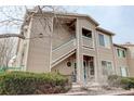 Exterior of the condo building featuring two floors, private balconies, and attractive landscaping at 8415 Pebble Creek Way # 102, Highlands Ranch, CO 80126